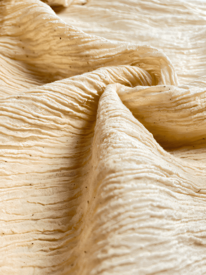 Neutral Stretchy Crinkle Cotton Fabric, Textured Surface.